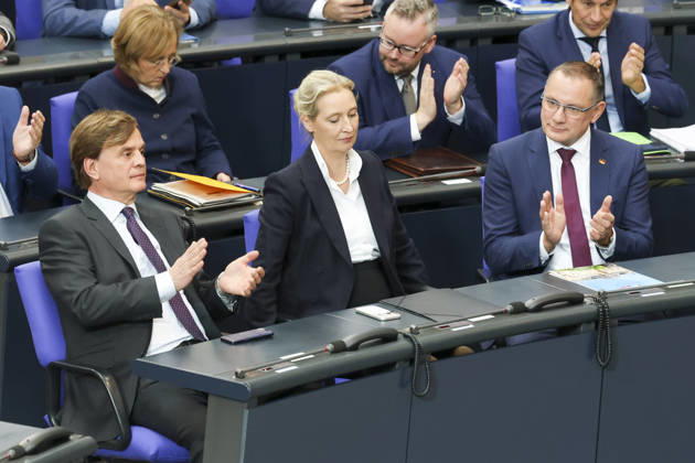 Bernd Baumann, Alice Weidel, and Tino Chrupalla at the session of the German Bundestag on October 14, 2026, in Berlin; Chancellor Merz delivering the government’s policy statement to the German Bundestag