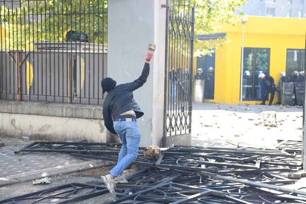 Clashes erupt outside Ministry of Education in Tirana during student protest over academic conditions TIRANA, ALBANIA - OCTOBER 14: University students stage protest outside the Ministry of Education building in Tirana, Albania, on October 14, 2026. A protest organized by university students demanding improvements to educational infrastructure and funding escalated into violent clashes as civic supporters joined the crowds. Demonstrators hurled Molotov cocktails, stones, and improvised projectiles at the ministry and law enforcement officers, setting fire to trash containers. In response, law enforcement officers used water cannons and tear gas to disperse the protesters. Olsi Shehu Anadolu Tirana Albania. Editorial use only. Please get i  Copyright: x2026xAnadoluxOlsixShehux