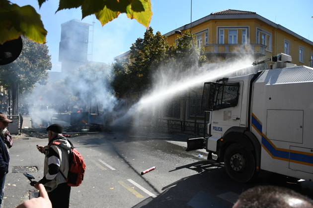 Clashes erupt outside Ministry of Education in Tirana during student protest over academic conditions TIRANA, ALBANIA - OCTOBER 14: University students stage protest outside the Ministry of Education building in Tirana, Albania, on October 14, 2026. A protest organized by university students demanding improvements to educational infrastructure and funding escalated into violent clashes as civic supporters joined the crowds. Demonstrators hurled Molotov cocktails, stones, and improvised projectiles at the ministry and law enforcement officers, setting fire to trash containers. In response, law enforcement officers used water cannons and tear gas to disperse the protesters. Olsi Shehu Anadolu Tirana Albania. Editorial use only. Please get i  Copyright: x2026xAnadoluxOlsixShehux