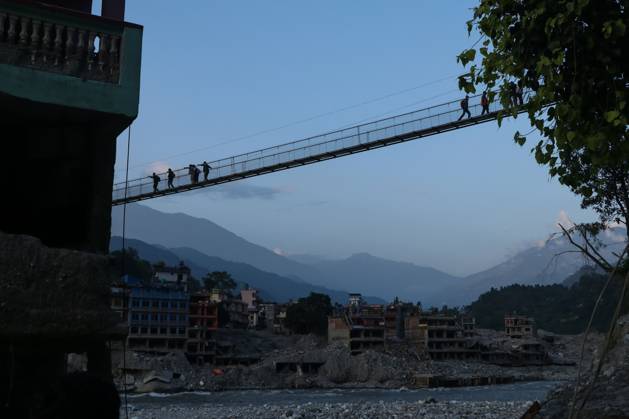 Nepal Bridge Restores Flood-Hit Access NUWAKOT, NEPAL, OCTOBER 14, 2026: Residents cross a newly built suspension bridge over the Trishuli River in Nuwakot, restoring access between communities affected by flash floods. Flooding destroyed bridges and damaged roads in the district, disrupting travel and access to essential services. NUWAKOT Nepal Copyright: x xShankarxBhujelx xJNAxPressx