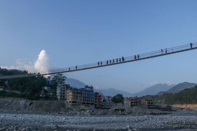 Nepal Bridge Restores Flood-Hit Access NUWAKOT, NEPAL, OCTOBER 14, 2026: Residents cross a newly built suspension bridge over the Trishuli River in Nuwakot, restoring access between communities affected by flash floods. Flooding destroyed bridges and damaged roads in the district, disrupting travel and access to essential services. NUWAKOT Nepal Copyright: x xShankarxBhujelx xJNAxPressx