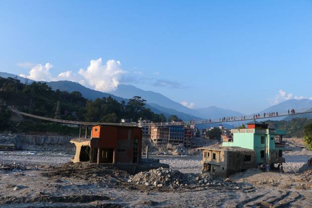 October 14, 2026, Nuwakot, Nepal: NUWAKOT, NEPAL, OCTOBER 14, 2026: Residents cross a newly built suspension bridge over the Trishuli River in Nuwakot, restoring access between communities affected by flash floods. Flooding destroyed bridges and damaged roads in the district, disrupting travel and access to essential services. Nuwakot Nepal - ZUMAq101 20261014_zna_q101_131 Copyright: xShankarxBhujelx