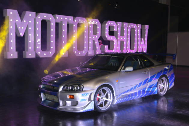 1999 Nissan Skyline R34 GT-R, original movie car from the 2003 film *2 Fast 2 Furious*, on display by ChromeCars in front of the Motor Show sign, Media event Carwalk for the Essen Motor Show on October 14, 2026, at Messe Essen in the run-up to the Essen Motor Show 2026 (November 28, 2026 – December 6, 2026), EMS Preview on November 27, 2026