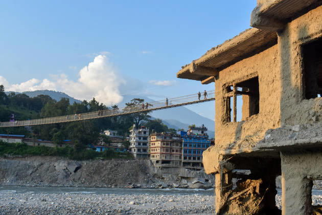 Aftermath of flash floods in Nepal NUWAKOT, NEPAL - OCTOBER 14 : People walk across a newly built suspension bridge over the Trishuli River, Nuwakot district, Nepal on October 14, 2026. Road and pedestrian connectivity has been restored with the construction of a new suspension bridge over the Trishuli River, allowing local residents to cross the river after the devastating floods damaged bridges and other infrastructure in the area. Sunil Pradhan Anadolu Nuwakot Nepal. Editorial use only. Please get in touch for any other usage.  Copyright: x2026xAnadoluxSunilxPradhanx