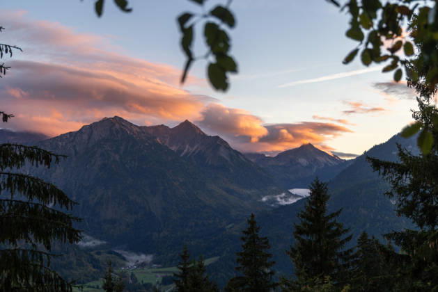 Autumn Evening in the Allgäu: The clouds in the sky glow in the evening sun above the peaks of the Allgäu Alps, Bad Hindelang, Bavaria, Germany