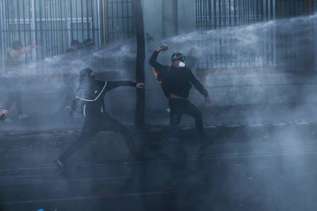 October 14, 2026, Tirana, Albania: TIRANA, ALBANIA, OCTOBER 14, 2026: Demonstrators clash with riot police during student-led protests over rising education costs, university conditions and alleged corruption in Tirana. Fires damage the Ministry of Education and bank premises as protesters throw stones and other objects, while police use tear gas and water cannons. Tirana Albania - ZUMAq101 20261014_zna_q101_290 Copyright: xVlasovxSulajx