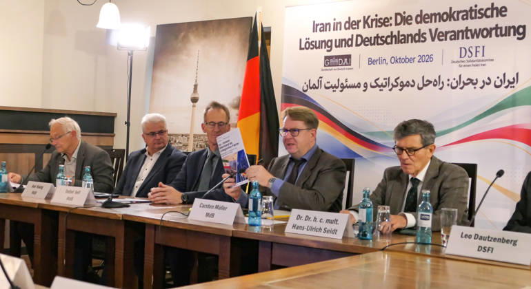 October 14, 2026, Berlin, Germany: German Bundestag Member, Carsten Müller seen presenting the publication Iran – Innerer Widerstand als strategischer Faktor at the conference table flanked by fellow parliamentarians Detlef Seif, Axel Knoerig, Dr. Hans-Ulrich Seidt and Martin Patzelt. The conference, titled Iran in Crisis: The Democratic Solution and Germany s Responsibility, was organized by the German Solidarity Committee for a Free Iran (DSFI) and the Association of German-Iranians (GDI) at Hopfingerbräu am Brandenburger Tor in Berlin, Germany, on October 14, 2026. The conference brought together German federal lawmakers, former diplomats, and witnesses to discuss human rights, democratic prospects for Iran, and an open letter si - ZUMAs197 20261014_aaa_s197_459 Copyright: xSiavoshxHosseinix
