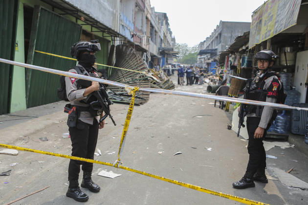 Blast at Indonesian market kills 2, injures 11 in South Tangerang BANTEN, INDONESIA - OCTOBER 15: Armed police officers stand guard at the site of an explosion at a market in South Tangerang, on the outskirt of Jakarta, Indonesia, on October 15, 2026. The blast killed two people and injured at least 11 others, according to police. Investigators are examining the cause of the explosion after finding an ethylene gas cylinder at the site. The blast damaged shop-house buildings and scattered debris across the surrounding commercial area. Agoes Rudianto Anadolu Banten Indonesia. Editorial use only. Please get in touch for any other usage.  Copyright: x2026xAnadoluxAgoesxRudiantox