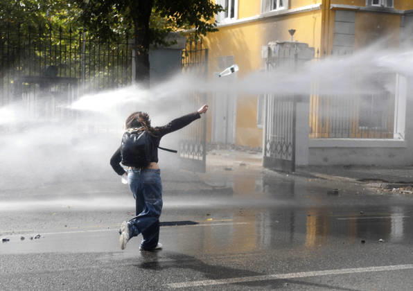 Protesters Clash with Police During a Demonstration in Tirana, Albania. A girl throws a water bottle at riot police during an anti-government demonstration in central Tirana on October 15, 2026, as protests continued for a third consecutive day over university conditions and demands for the resignation of Albanian Prime Minister Edi Rama. The latest rally follows two nights of violence in the capital, during which protesters and riot police clashed, police used water cannons and tear gas, and demonstrators damaged government offices and shops and set fire to several buildings. Light Studio Agency Malton Dibra Tirana Albania Copyright: xLightxStudioxAgencyx xMaltonxDibrax