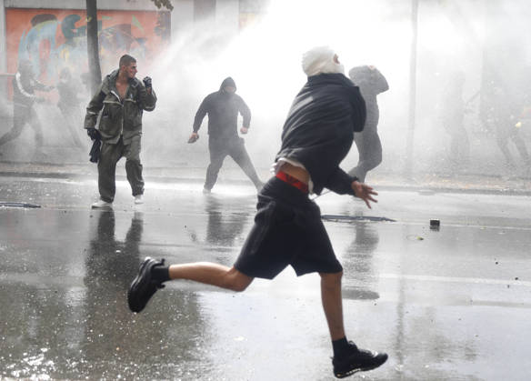 Protesters Clash with Police During a Demonstration in Tirana, Albania. Protesters throw stones at riot police during an anti-government demonstration in central Tirana on October 15, 2026, as protests continued for a third consecutive day over university conditions and demands for the resignation of Albanian Prime Minister Edi Rama. The latest rally follows two nights of violence in the capital, during which protesters and riot police clashed, police used water cannons and tear gas, and demonstrators damaged government offices and shops and set fire to several buildings. Light Studio Agency Malton Dibra Tirana Albania Copyright: xLightxStudioxAgencyx xMaltonxDibrax