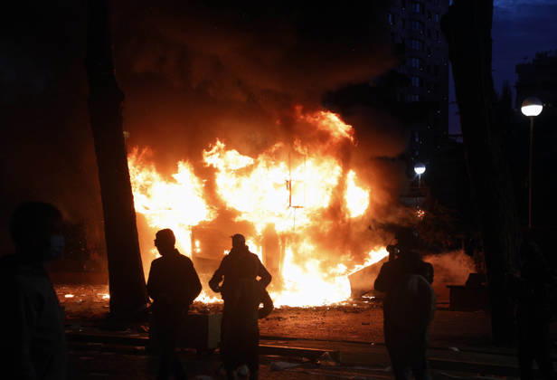 Protesters Clash with Police During a Demonstration in Tirana, Albania. Protesters walk in front of a burning kiosk during an anti-government demonstration in central Tirana on October 15, 2026, as protests continued for a third consecutive day over university conditions and demands for the resignation of Albanian Prime Minister Edi Rama. The latest rally follows two nights of violence in the capital, during which protesters and riot police clashed, police used water cannons and tear gas, and demonstrators damaged government offices and shops and set fire to several buildings. Light Studio Agency Malton Dibra Tirana Albania Copyright: xLightxStudioxAgencyx xMaltonxDibrax