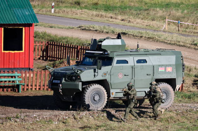 BELARUS - OCTOBER 16, 2026: Servicemen appear next to an armoured vehicle in the final live training phase of the Indestructible Brotherhood 2026 command-and-staff military exercise by the CSTO Peacekeeping Forces at the Losvido military training ground. Maxim Malinovsky TASS  99408802