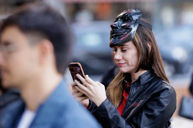 Solidarity Protest for Albania held in Berlin. A protester looks at her phone as people gather opposite the Albanian embassy during a protest organized by ˜Flamingos von Berlin™ in Berlin, Germany, 16 October 2026. The organizers called for solidarity with students in Albania and denounced corruption, demanding the resignation of Edi Rama. Berlin