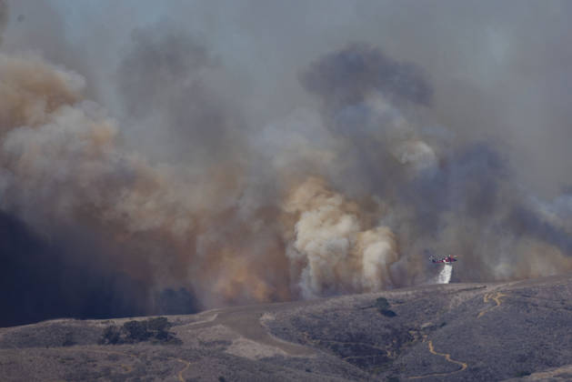 October16, 2026, San Juan Capistrano, California, USA: Fire crews are aggressively battling a wind-driven brush fire that burned several homes and threatened thousands of others in the area of San Juan Capistrano and San Clemente Friday, prompting evacuation orders. The Norte Fire exploded to 465 acres and remains 0 percent contained as of 4 p.m. O.C. Fire Authority officials said the Norte Fire started around 11:30 a.m. near Portico Del Norte and Eminencia Del Norte in San Clemente, east of Interstate 5. Fueled by strong Santa Ana winds, the wildfire then blew into neighboring San Juan Capistrano. San Juan Capistrano USA - ZUMAr19_ 20261016_new_r19_159 Copyright: xRuaridhxStewartx
