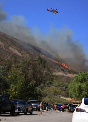 October16, 2026, San Juan Capistrano, California, USA: Fire crews are aggressively battling a wind-driven brush fire that burned several homes and threatened thousands of others in the area of San Juan Capistrano and San Clemente Friday, prompting evacuation orders. The Norte Fire exploded to 465 acres and remains 0 percent contained as of 4 p.m. O.C. Fire Authority officials said the Norte Fire started around 11:30 a.m. near Portico Del Norte and Eminencia Del Norte in San Clemente, east of Interstate 5. Fueled by strong Santa Ana winds, the wildfire then blew into neighboring San Juan Capistrano. San Juan Capistrano USA - ZUMAr19_ 20261016_new_r19_171 Copyright: xRuaridhxStewartx