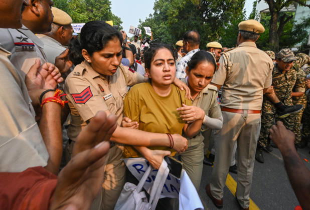 NEW DELHI, INDIA - OCTOBER 17: Delhi Police and paramilitary personnel detain members and workers of various organisations during a protest against Chief Election Commissioner Gyanesh Kumar and the Special Intensive Revision (SIR) of electoral rolls on Raisina Road on October 17, 2026 in New Delhi, India. (Photo by Raj K Raj Hindustan Times ) CJP Supporters Protest Demanding CEC Gyanesh Kumar s Resignation Over Voter List Changes