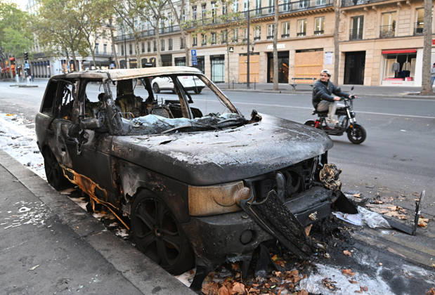 Aftermath of clashes during nationwide protests in Paris PARIS, FRANCE - OCTOBER 18: A scooter rider looks at a burnt-out vehicle following clashes during nationwide protests against the high cost of living and rising fuel prices in Paris, France on October 18, 2026. Mustafa Yalcin Anadolu Paris France. Editorial use only. Please get in touch for any other usage.  Copyright: x2026xAnadoluxMustafaxYalcinx