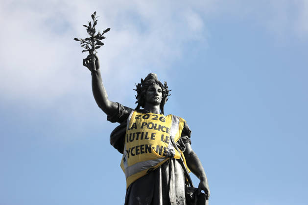 The statue of Marianne is clad in a yellow vest tagged with Ã‡Ãä2026 : The police maim high school studentsÃäÃˆ, at Republique Square in Paris, on Sunday, October 18, 2026. Residents awoke to scenes of widespread damage with shopfronts shattered, burnt out cars, charred bikes, and piles of glass and debris on the pavements of the French capital a day after riots erupted during protests against rising fuel prices, the cost of living and deteriorating public services, including schools.  PAR20261018103 MAYAxVIDON-WHITE