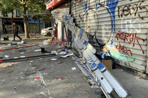 A man walks past a vandalised shop near Republique Square in Paris, on Sunday, October 18, 2026. Residents awoke to scenes of widespread damage with shopfronts shattered, burnt out cars, charred bikes, and piles of glass and debris on the pavements of the French capital a day after riots erupted during protests against rising fuel prices, the cost of living and deteriorating public services, including schools.  PAR20261018113 MAYAxVIDON-WHITE
