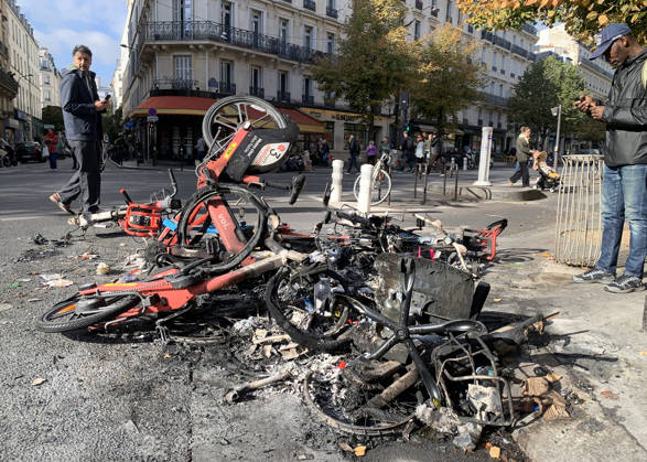 Men look at a pile of burnt-out bicycles near Republique Square in Paris, on Sunday, October 18, 2026. Residents awoke to scenes of widespread damage with shopfronts shattered, burnt out cars, charred bikes, and piles of glass and debris on the pavements of the French capital a day after riots erupted during protests against rising fuel prices, the cost of living and deteriorating public services, including schools.  PAR20261018116 MAYAxVIDON-WHITE