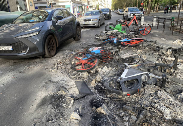 Cars avoid a pile of burnt-out bicyles near Republique Square in Paris, on Sunday, October 18, 2026. Residents awoke to scenes of widespread damage with shopfronts shattered, burnt out cars, charred bikes, and piles of glass and debris on the pavements of the French capital a day after riots erupted during protests against rising fuel prices, the cost of living and deteriorating public services, including schools.  PAR20261018117 MAYAxVIDON-WHITE