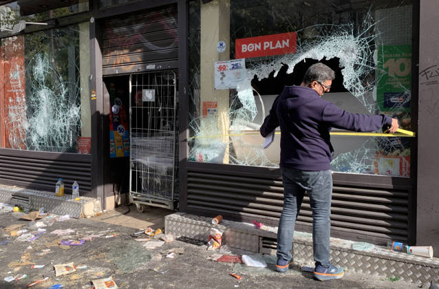 A shop owner measures the damage to his vandalised grocery store near Republique Square in Paris, on Sunday, October 18, 2026. Residents awoke to scenes of widespread damage with shopfronts shattered, burnt out cars, charred bikes, and piles of glass and debris on the pavements of the French capital a day after riots erupted during protests against rising fuel prices, the cost of living and deteriorating public services, including schools.  PAR20261018119 MAYAxVIDON-WHITE