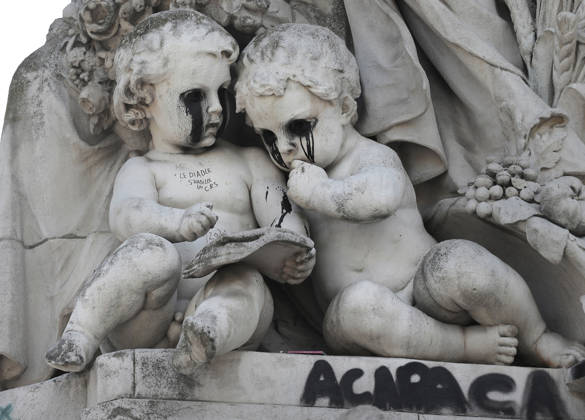 The eyes of the two children symbolizing knowledge at the foot of the statue of Fraternity have been blacked out at Republique Square in Paris, on Sunday, October 18, 2026. Residents awoke to scenes of widespread damage with shopfronts shattered, burnt out cars, charred bikes, and piles of glass and debris on the pavements of the French capital a day after riots erupted during protests against rising fuel prices, the cost of living and deteriorating public services, including schools.  PAR202610181051 MAYAxVIDON-WHITE
