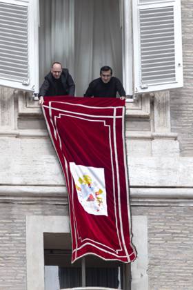 October 18, 2026, Vatican City, Vatican: Pope Leo XIV s personal secretaries, Father Marco Billeri and Monsignor Edgard Ivan Rimaycuna Inga, hang a tapestry bearing the pontiff s coat of arms from a window of Pope s study overlooking St. Peter s Square, before the traditional Angelus prayer at the Vatican.Pope Leo XIV during Sunday Angelus Prayer in Vatican Vatican City Vatican  - ZUMAs197 20261018_aaa_s197_001 Copyright: xMariaxGraziaxPicciarellax