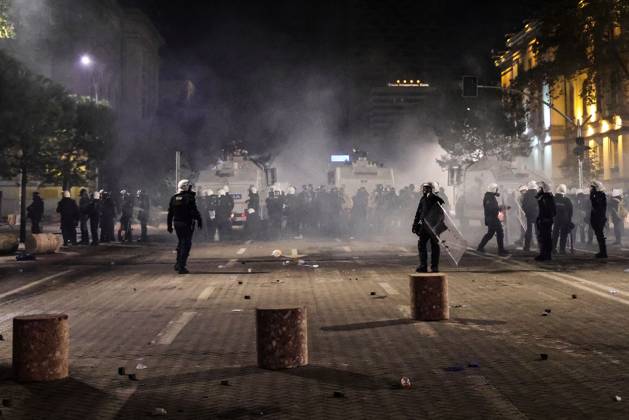 October 18, 2026, Tirana, Albania: TIRANA, ALBANIA, OCTOBER 18, 2026: Demonstrators clash with riot police in Skanderbeg Square as student-led anti-government protests continue for a sixth consecutive day. Confrontations spread from the Ministry of Education to central Tirana, with protesters throwing stones and pyrotechnics while police deploy tear gas and water cannons. Demonstrators demand improved university conditions and the resignation of Prime Minister Edi Rama. Tirana Albania  - ZUMAq101 20261018_zna_q101_227 Copyright: xVlasovxSulajx