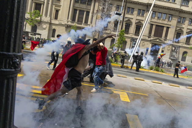 October 19, 2026, Santiago, Chile: A man returns a tear gas bomb at the police. In the center of the capital of Chile, different incidents took place between demonstrators and the police. The riots were carried out during the commemoration of the 7 years after the social outcast that happened on October 18, 2019. Santiago Chile  - ZUMAs197 20261019_aaa_s197_009 Copyright: xSebastianxNancox