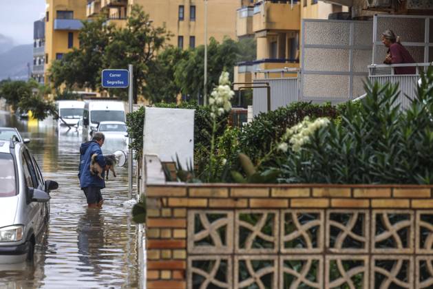 The Valencian Regional Government is preparing a lockdown order for the southern coast of Valencia and the northern coast of Alicante due to the rains. A man walks through a flooded area with a dog on October 19, 2026, in Guardamar de la Safor, Valencia, Valencian Community, Spain. The Valencian Regional Government is preparing a lockdown order for the southern coast of Valencia and the northern coast of Alicante in response to the emergency declared due to the rains brought by Storm Adam, as announced by the Regional Minister of Emergencies and the Interior early this morning, October 19, from the Emergency Coordination Center (CCE) October 19, 2026, Valencia, Valencian Community, Spain Copyright: xRoberxSolsonax 7855284