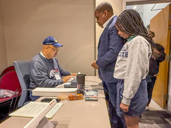 October 19, 2026, Little Rock, Arkansas, USA: Poll worker JERRY SAXTON checks in Democratic Congressional candidate CHRIS JONES so he can cast his ballot on the first day of early vote in Arkansas. Jones is accompanied in line by his daughter, JASMINE JONES. Jones is running for the seat now held by Rep. French Hill (R-AR). Should Jones win, he will be the first Black person Arkansas sends to Congress. Little Rock USA - ZUMAd155 20261019_znp_d155_027 Copyright: xSuexDorfmanx