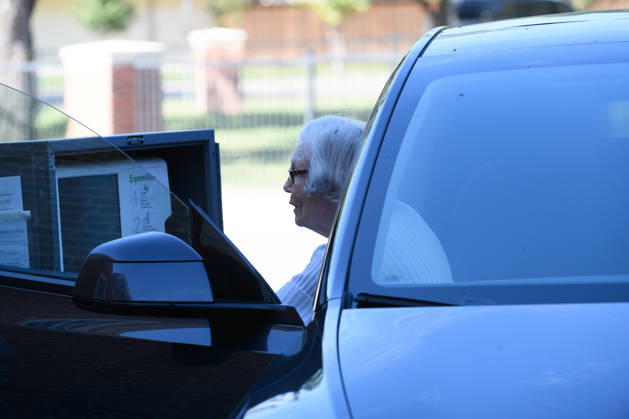 October 19, 2026, Dallas, Texas, USA: Early voting started in Dallas TX on Monday morning...University Park United Methodist Church..By 1130 am, nearly 700 people voted at this location..Election worker helps a citizen vote curbside. Dallas USA - ZUMAa183 20261019_znp_a183_024 Copyright: xAvixAdelmanx