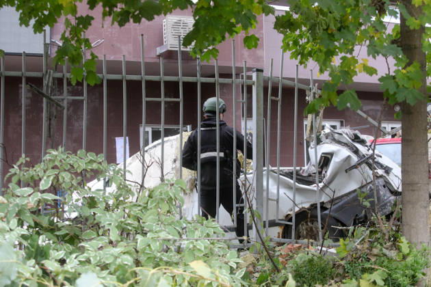 A forensic expert stands by a car damaged by a Russian drone strike on an apartment block in the Sviatoshynskyi district, Kyiv, Ukraine, October 21, 2026. The drone hit the building’s 20th floor, sparking a fire. Two people were killed in the attack. (Photo by Volodymyr Tarasov Ukrinform) Russian drone hits 24-storey apartment block in Kyiv  Copyright: xVolodymyrxTarasovx