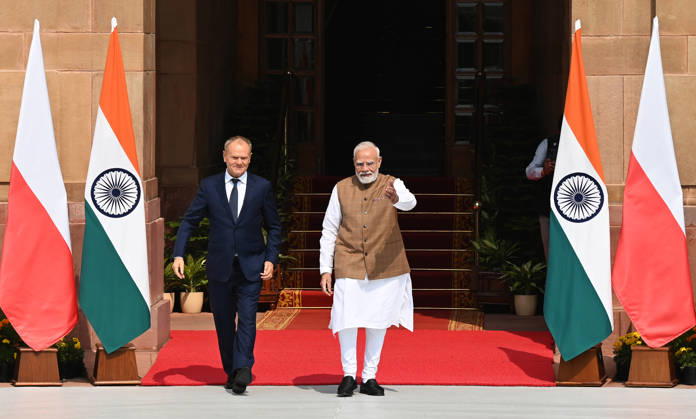 NEW DELHI, INDIA - OCTOBER 22: Prime Minister Narendra Modi (R) welcomes Prime Minister of Poland, Donald Tusk (L), prior to their delegation-level bilateral meeting and joint press statement at Hyderabad House on October 22, 2026 in New Delhi, India. The high-level meeting marked Polish Prime Minister Tusk s official visit to India from October 21-23, 2026 his first visit to the country as Prime Minister since 2010 aimed at advancing the India-Poland Strategic Partnership and deepening India-EU strategic ties. During wide-ranging discussions, both leaders reviewed bilateral cooperation across key sectors including trade, technology, defense-industrial collaboration, and energy, while reaffirming joint commitment toward peaceful diplomatic