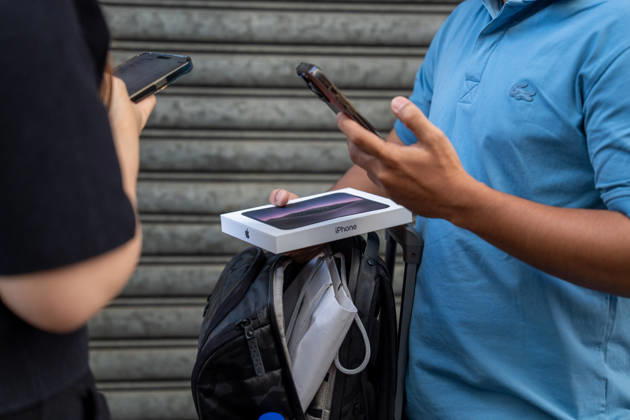 First Day on sale of IPhone Duo in Hong Kong iPhone resellers trying to buy an iPhone Duo from a customers outside an Apple Store on October 22, 2026 in Hong Kong. The iPhone DUO is Apple INC.™s first foldable phone, today is the first day the new iPhone DUO is available to the public. (Photo by Vernon Yuen Nexpher Images) HONG KONG HONG KONG