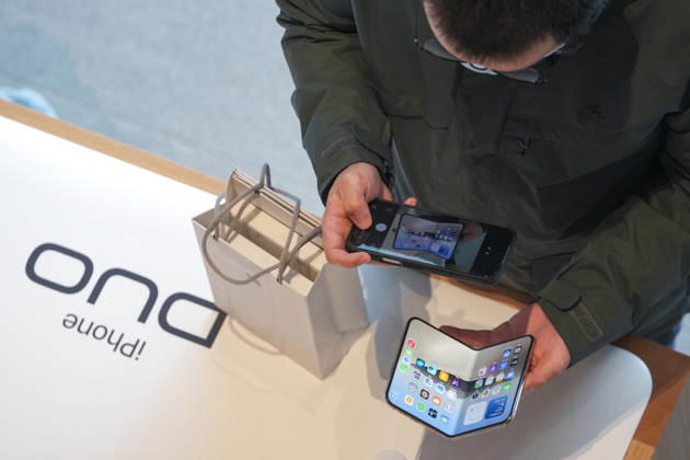 Apple s New iPhone Duo goes on sale in China BEIJING, CHINA - OCTOBER 23: Customers try iPhone Duo smartphone at Apple Inc. s Sanlitun store during the first day of in-store sales of the new device in Beijing, China, on Friday, Oct. 23, 2026. Stringer Anadolu Beijing China. Editorial use only. Please get in touch for any other usage.  Copyright: x2026xAnadoluxStringerx