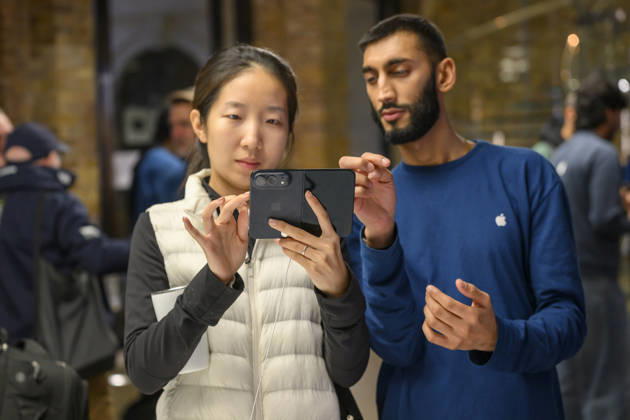 October 23, 2026, London, London, UK: London, UK. Customers inside the Apple Covent Garden store view and buy the new Apple iPhone Duo, the companyâ€⠢s first foldable iPhone. Opened, it is the thinnest iPhone ever, with a 7.6-inch inner display that provides a large canvas for viewing content, gaming, and multitasking, and a special nano-texture finish that minimises glare for an unparalleled viewing experience. Closed, the 5.4-inch outer display delivers 90 percent of the screen area of iPhone 18 Pro in a compact, pocketable design. London UK - ZUMAl94_ 20261023_zaf_l94_021 Copyright: xRayxTangx