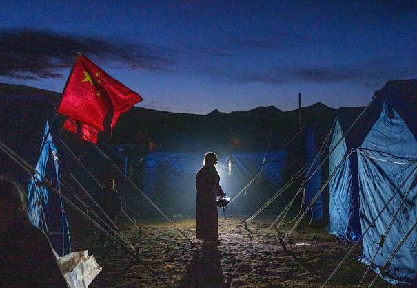 (261023) -- NAGQU, Oct. 23, 2026 -- A villager prepares to fill her kettle with hot water at a temporary resettlement site of an earthquake-hit village in Maru Township of Baqen County, Nagqu City, southwest China s Xizang Autonomous Region, Oct. 23, 2026. China has allocated 50 million yuan (about 7.5 million U.S. dollars) in emergency disaster relief funds and earmarked another 30 million yuan for recovery efforts following a 7.0-magnitude earthquake in southwest China s Xizang Autonomous Region. The earthquake struck Baqen County of the city of Nagqu at 10:33 p.m. on Thursday, leaving 16 people dead and 54 injured. ) (SpotNews) CHINA-XIZANG-NAGQU-EARTHQUAKE-RESETTLEMENT (CN) TenzinxNyida 
