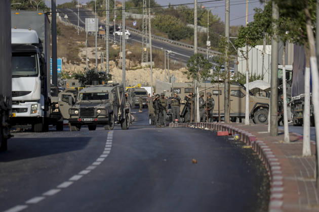 Hebron West Bank Shooting Attack Israeli military vehicles stand guard at the entrance to Farsh al-Hawa near Hebron, in the occupied West Bank on October 23, 2026. Journalists were targeted and the area was declared a closed military zone following a Palestinian shooting attack targeting an Israeli military checkpoint at the entrance to Farsh al-Hawa in Hebron. Hebron West Bank Palestinian Territories Copyright: xMosabxShawerx
