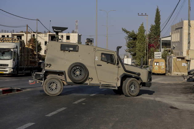 Hebron West Bank Shooting Attack An Israeli military vehicle stands guard at the entrance to Farsh al-Hawa near Hebron, in the occupied West Bank on October 23, 2026. Journalists were targeted and the area was declared a closed military zone following a Palestinian shooting attack targeting an Israeli military checkpoint at the entrance to Farsh al-Hawa in Hebron. Hebron West Bank Palestinian Territories Copyright: xMosabxShawerx