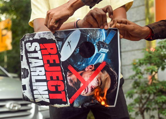 Swadeshi Jagaran Manch Members And Supporters Stage A Protest Against Starlink in New Delhi New Delhi, Oct 23 (ANI): A protester holds a placard during a protest staged by Swadeshi Jagaran Manch members and supporters against Tesla CEO Elon Musk s satellite-based internet services, Starlink, in New Delhi on Friday. NEW DELHI Delhi India Copyright: xANIx ANI_20261023103