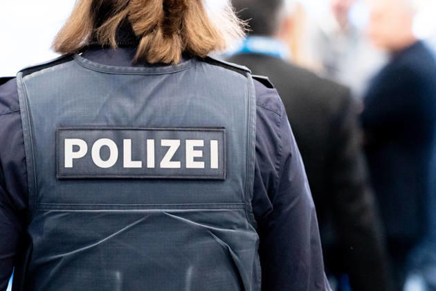Munich, Bavaria, Germany - October 23, 2026: The 2026 convention of the CSU (Christian Social Union) at the Munich Trade Fair Center. Background detail: A female police officer in uniform