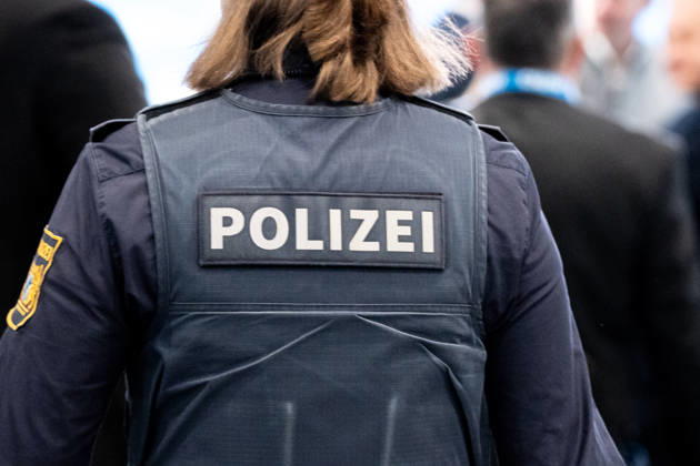Munich, Bavaria, Germany - October 23, 2026: The 2026 convention of the CSU (Christian Social Union) at the Munich Trade Fair Center. Background detail: A female police officer in uniform