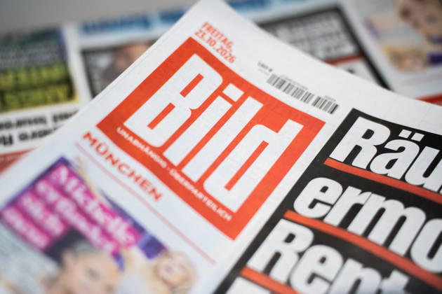 Munich, Bavaria, Germany October 23, 2026: The 2026 convention of the CSU (Christian Social Union) at the Munich Trade Fair Center. Background detail: a stack of newspapers, copies of the daily newspaper BILD published by Axel Springer Verlag