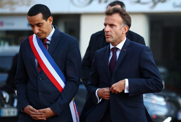 French President Macron in Trappes After Deadly Shooting - France French President Emmanuel Macron walks with Mayor of Trappes Ali Rabeh as he arrives for a meeting at the town hall after a drive-by shooting during which a person was killed and at least four others were wounded including a 12-year-old girl, in Trappes, in the Yvelines department, near Paris, France, October 23, 2026. Photo by Hannah McKay Pool ABACAPRESS.COM Trappes France  Copyright: xMcKayxHannah Pool ABACAx