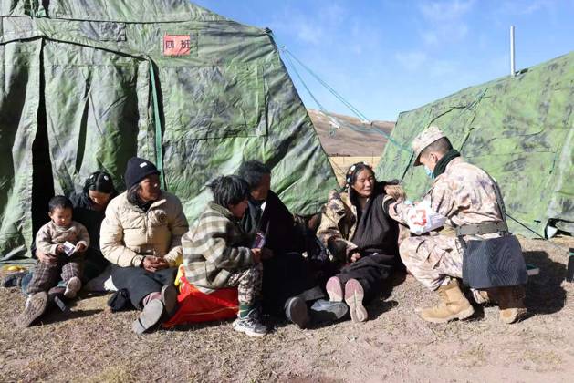 (261024) -- NAGQU, Oct. 24, 2026 -- A military health worker from a local subcommand of the Western Theater Command of the Chinese People s Liberation Army takes care of local residents at a temporary resettlement site of a quake-hit village in Maru Township of Baqen County, Nagqu City, southwest China s Xizang Autonomous Region, Oct. 23, 2026. Sixteen people have been killed and 76 others are injured following a 7.0-magnitude earthquake that struck Baqen County of the city of Nagqu in southwest China s Xizang Autonomous Region at 10:33 p.m. on Thursday, local authorities said. The Western Theater Command of the Chinese People s Liberation Army has coordinated ground and air forces to assess the damage and carry out search-and-rescue o 