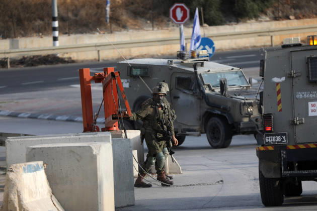 (261024) -- HEBRON, Oct. 24, 2026 -- Israeli military forces are seen at an Israeli military checkpoint near the northern entrance to Hebron City, in the West Bank, on Oct. 24, 2026. Israeli forces launched a military operation in the West Bank city of Hebron on Friday night, hours after Israeli leaders vowed to displace residents and carry out demolitions following a shooting attack near the city that killed two Israeli soldiers. Prime Minister Benjamin Netanyahu also vowed to expand military operations and demolitions in Hebron, four days before Israel s parliamentary election. (Photo by Xinhua) MIDEAST-HEBRON-MILITARY-OPERATION MamounxWazwaz 