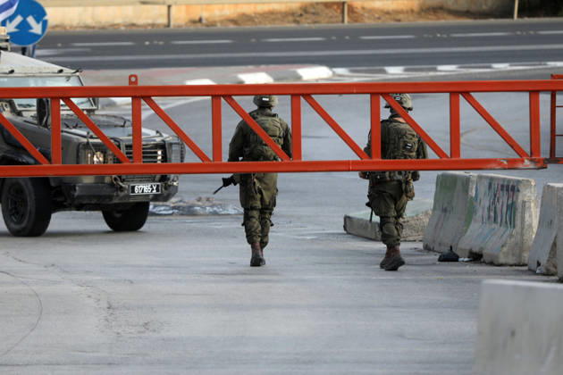 (261024) -- HEBRON, Oct. 24, 2026 -- Israeli military forces are seen at an Israeli military checkpoint near the northern entrance to Hebron City, in the West Bank, on Oct. 24, 2026. Israeli forces launched a military operation in the West Bank city of Hebron on Friday night, hours after Israeli leaders vowed to displace residents and carry out demolitions following a shooting attack near the city that killed two Israeli soldiers. Prime Minister Benjamin Netanyahu also vowed to expand military operations and demolitions in Hebron, four days before Israel s parliamentary election. (Photo by Xinhua) MIDEAST-HEBRON-MILITARY-OPERATION MamounxWazwaz 