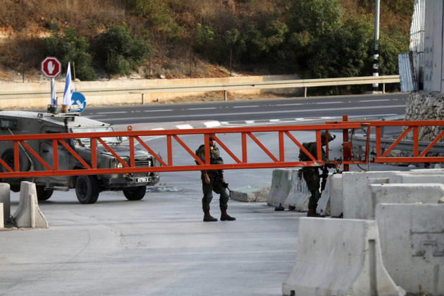 (261024) -- HEBRON, Oct. 24, 2026 -- Israeli military forces are seen at an Israeli military checkpoint near the northern entrance to Hebron City, in the West Bank, on Oct. 24, 2026. Israeli forces launched a military operation in the West Bank city of Hebron on Friday night, hours after Israeli leaders vowed to displace residents and carry out demolitions following a shooting attack near the city that killed two Israeli soldiers. Prime Minister Benjamin Netanyahu also vowed to expand military operations and demolitions in Hebron, four days before Israel s parliamentary election. (Photo by Xinhua) MIDEAST-HEBRON-MILITARY-OPERATION MamounxWazwaz 